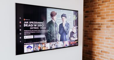Smart TV displaying streaming content in modern living room setting with exposed brick wall.